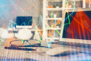 Financial chart drawing and table with computer on background. Double exposure. Concept of...