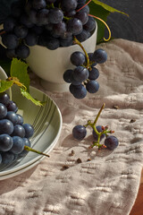 Grapes on a white saucer and a dark background.