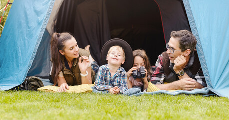 Family having fun camping in their house garden