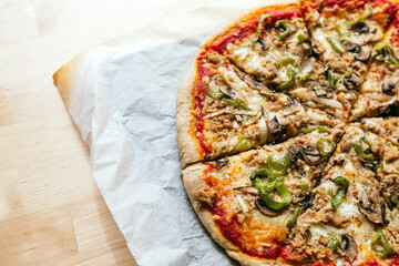 Close-up of a delicious homemade italian pizza with cheese, tomatoes, mushrooms and green pepper