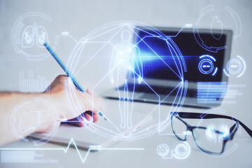 Man's hands working with notes background. Modern computer record diagram with virtual mnitor.
