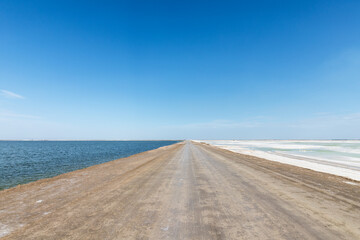 dirt road with salt lake