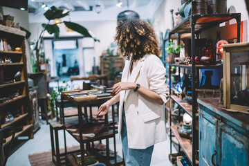 Fototapeta premium Ethnic woman in shop looking away
