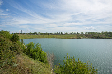 Flooded open pit quarry with blue water lake