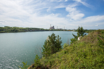 Flooded open pit quarry with blue water lake