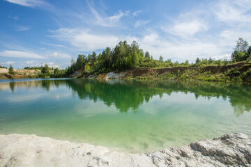 Fototapeta na wymiar Blue water kaolin quarry lake pond