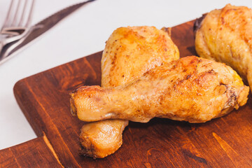 Fried crispy chicken legs, Thigh wooden cutting board with spice on table