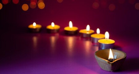 Obraz na płótnie Canvas Happy Diwali - Clay Diya lamps lit during Dipavali, Hindu festival of lights celebration