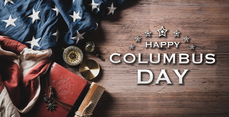 Happy Columbus Day concept. Vintage American flag with compass and treasure manuscript with Happy Columbus text on dark wooden background.
