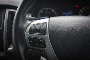Obraz na płótnie Canvas Modern car dashboard. The past of dashboard on steering wheel. Closeup interior modern car. Audio control button on the steering wheel inside the car.