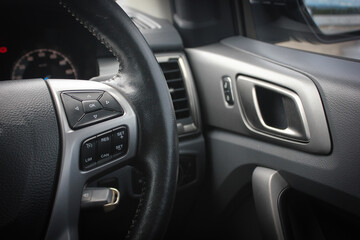Fototapeta na wymiar Modern car dashboard. The past of dashboard on steering wheel. Closeup interior modern car. Audio control button on the steering wheel inside the car.
