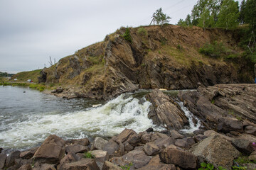 Fototapeta na wymiar River waterfall in the mountains