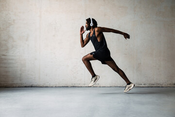 Image of african american sportsman running while working out