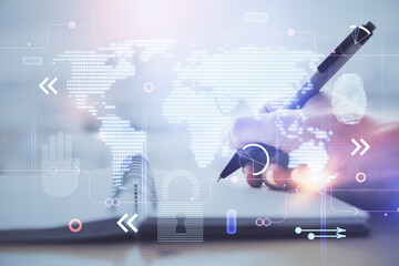 Double exposure of hands making notes with world map hologram and data theme icons. Concept of global computer data.