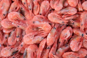 Piles of frozen prawns
