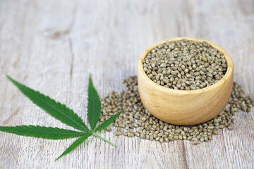 Cannabis seeds, wooden cups and cannabis leaves to extract hemp oil The concept of extracting hemp leaves is a natural healing oil, natural herbal medicine. Alternative medicine treatment.