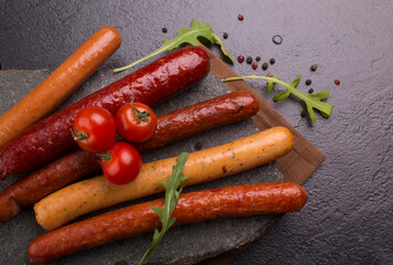 sausages and vegetables on a stone