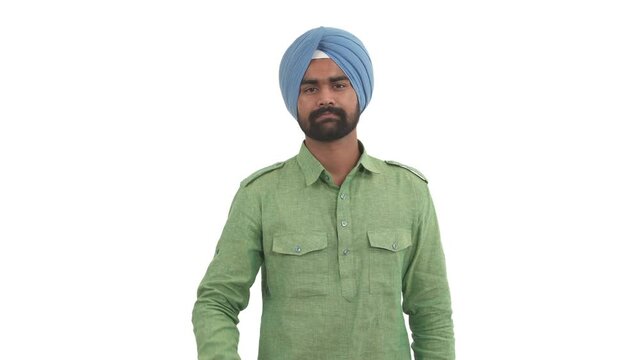 Portrait of Indian beard man showing thumbs up and nodding head. Body language concept. Isolated on white background.