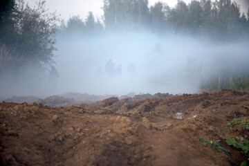 Smoke bombs action. A group of soldiers on a field position.