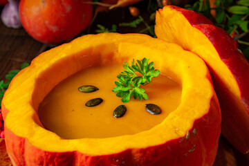 Delicious autumn pumpkin soup with baguette