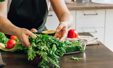 Woman cooking healthy food - vegetable salad. Dieting Concept. Healthy Lifestyle. Cooking At Home. Prepare Food