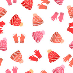 Doodle cozy red, orange and pink gloves, wool hats on white background. Seamless winter clothes pattern. Suitable for packaging, textile, wallpaper.