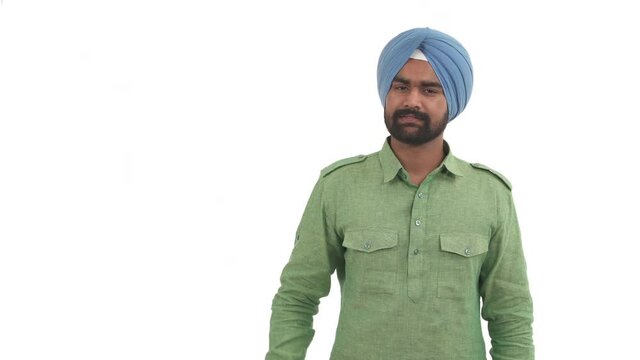 Indian beard man pointing to left side and nodding head as if agreeing with someone. Isolated on white background.