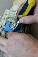 man is independently repairing parts for a car. replacing the gas pump at home with your own