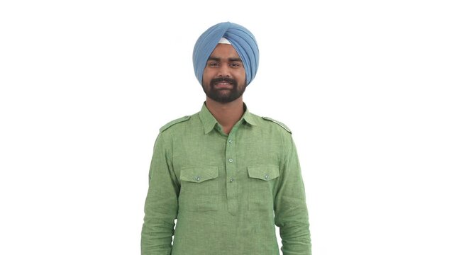 Portrait of laughing Indian man pointing on camera with index finger expressing mockery emotion. Guy making fun of someone. Isolated on white background