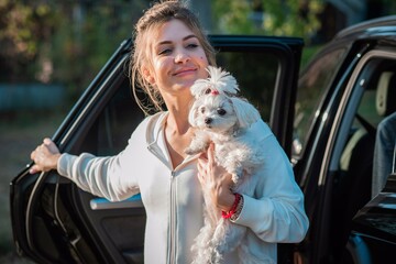 Woman with a Little fashionable luxury lapdog dog at walk, pet lifestyle