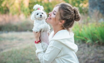Woman with a Little fashionable luxury lapdog dog at walk, pet lifestyle