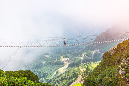 View of the mountain landscape gorge, tourist human walking along an extreme staircase over a precipice.