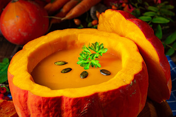 Delicious autumn pumpkin soup with baguette