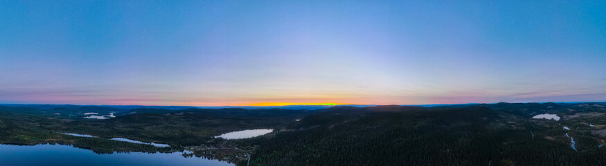 Panorama view over forest wilderness in Scandinavia at sunset.