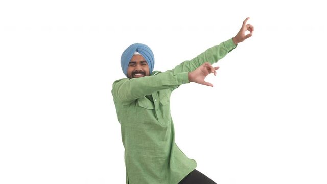 Smiling Indian beard man in dastar dancing in Bollywood style. Folk dance concept. Isolated on white background