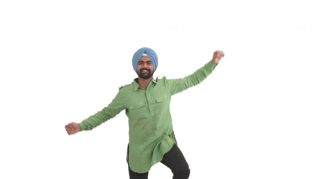 Young beard Indian man performing traditional dance movement in Bollywood style. Folk dance concept. Isolated on white background