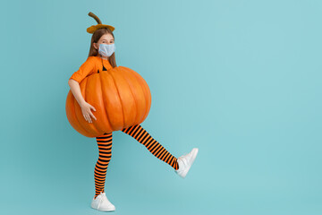 girl in pumpkin costume  wearing face mask