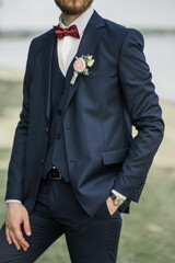 Details of the groom on the wedding day. Groom's boutonniere.