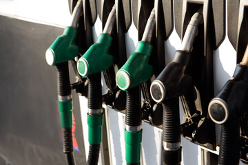 Petrol pump filling nozzles isolated on blsck background , Gas station in a service