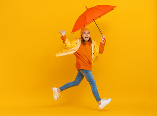 Kid with umbrella on colored background.