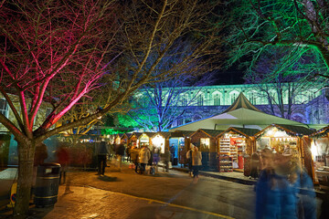 Revellers at Christmas market outside Winchester Cathedral, Hampshire, UK