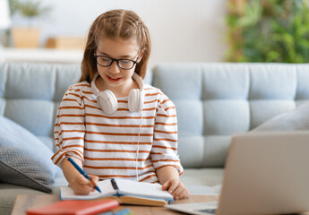 Fototapeta premium Girl doing homework or online education.