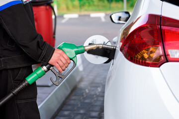 Naklejka premium Gas station attendant at work. Car refueling on a petrol station.