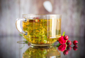 natural hot tea from various summer herbs in a glass cup