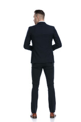Back view of mysterious businessman looking over shoulder
