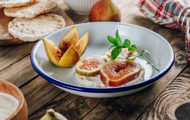 Healthy snack wholegrain rice crispbread crackers, figs and ricotta cheese on rustic wooden background.