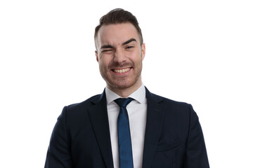 Cheerful businessman winking and laughing