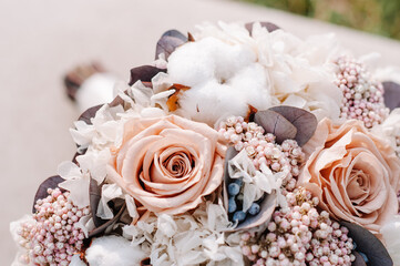 Closeup of beautiful pink rose bouquet held by a gracious bride