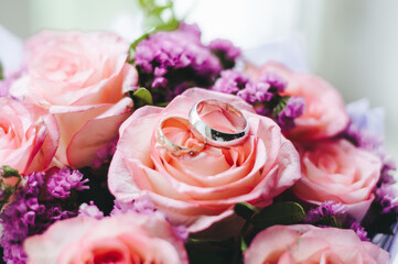 Closeup of beautiful pink rose bouquet held by a gracious bride