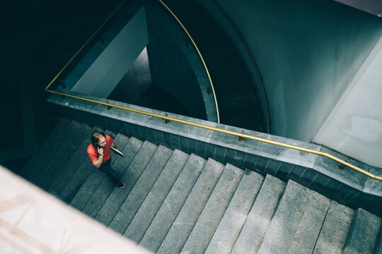 Young man climbing stairs in building
